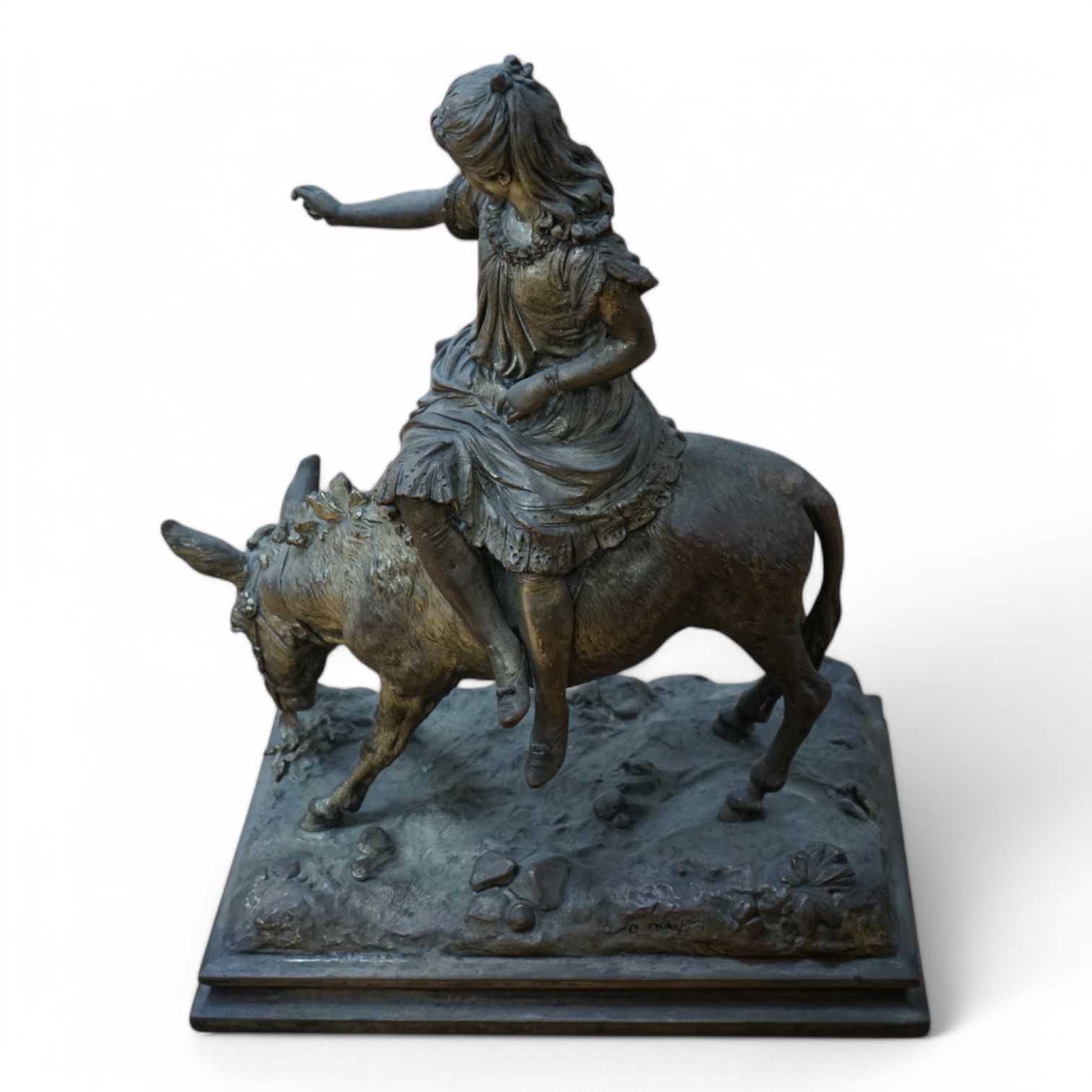 A silvered resin figure of a girl on a donkey, 45cm high. Condition - poor